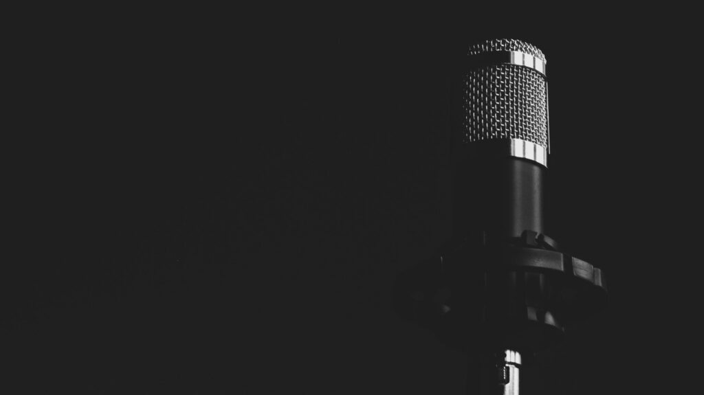 pexels-photo-302655-302655 Close-up view of a studio microphone against a dark background, emphasizing audio technology.